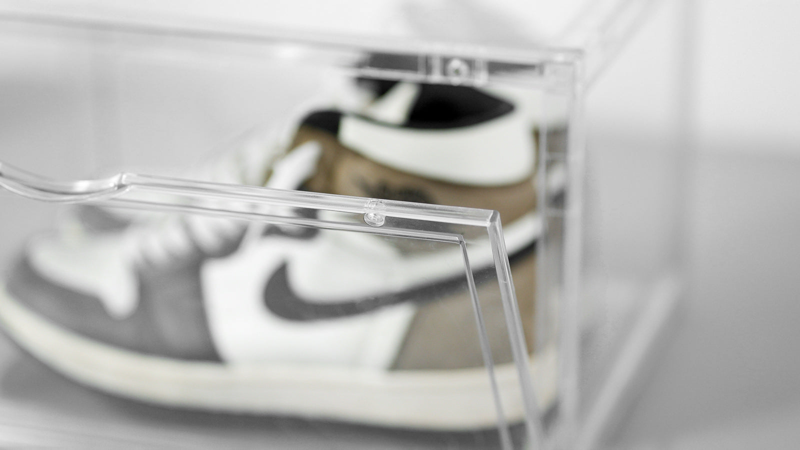 Close-up of a sneaker inside a clear SPBOX display case