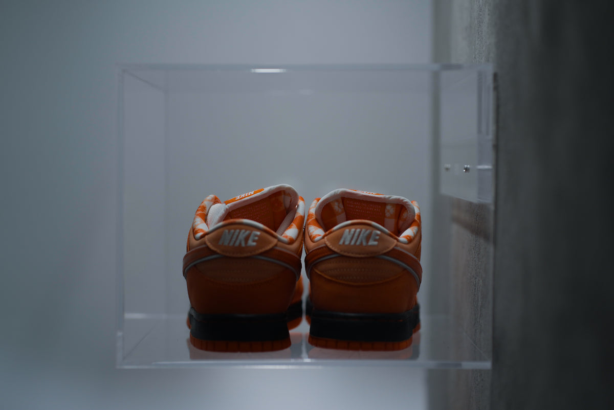 A pair of sneakers sealed inside a crystal-clear SPBOX display case
