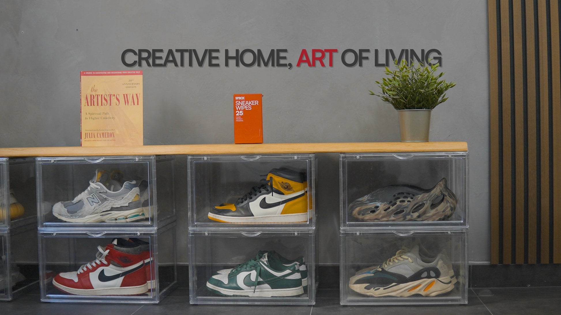 Six stacked SPBOX Ultimate Sneaker Display boxes in a home hallway, each showing a different sneaker